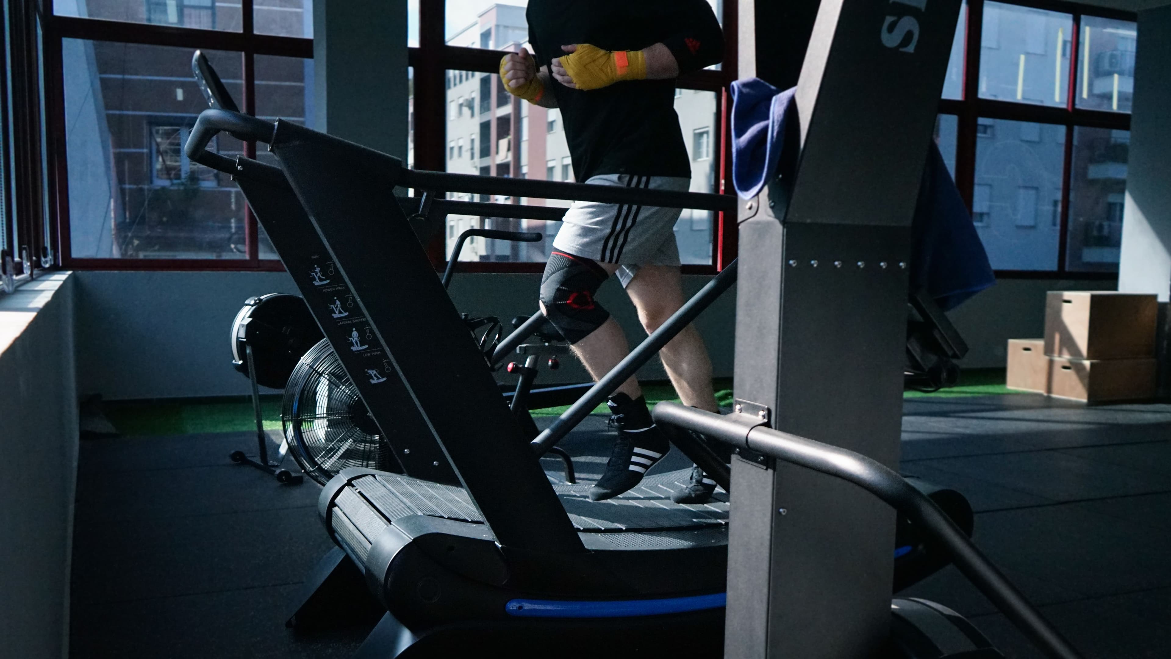 A person doing steady treadmill cardio in a gym, representing Zone 2 training and controlled aerobic effort